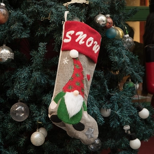 Grey herringbone Christmas stocking with 3D gnome and SNOW embroidery on a festive tree