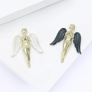 Elegant gold angel wing brooches in white and dark grey enamel on minimalist background