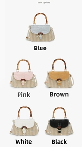 Detail view of woven straw handbags with bamboo handles and floral embroidery in five colors