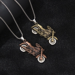 Retro motorcycle pendant necklaces in bronze and copper finish on black background