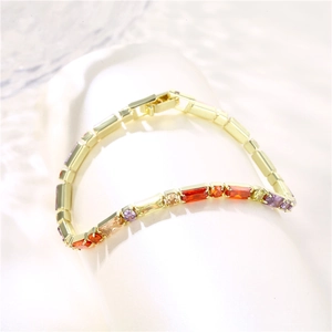 Elegant gold plated bracelet with rectangular multicolor 3A zircons on a white stand