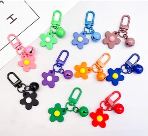Close-up of colorful flower keychains with matching bells and lobster clasps