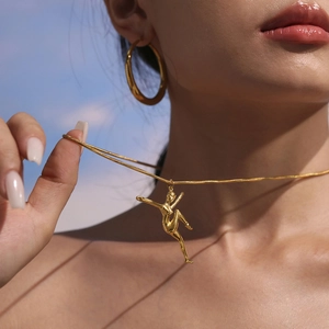 Elegant gold dancing figure pendant necklace with snake chain for modern women jewelry style