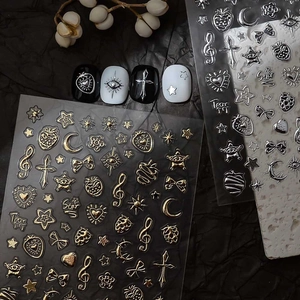 Detailed view of metallic gold and silver nail stickers with celestial moon and star designs