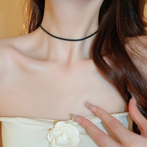 Minimalist black synthetic leather geometric choker necklace for women worn by a model