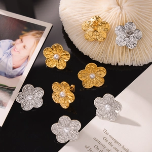 Textured flower stud earrings with pearl center in gold and silver finish