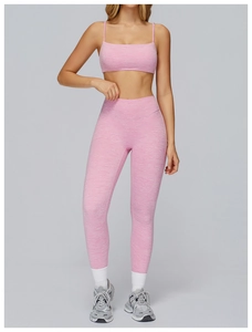 Detailed view of pink brushed yoga leggings and sports bra with high-waisted slim fit design
