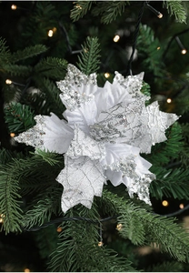 Silver glitter artificial Christmas flower with fabric petals on a pine tree