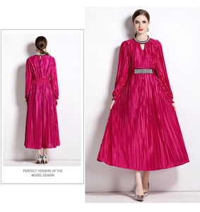 Close-up of beaded neckline and pleated waist detail on a fuchsia maxi dress