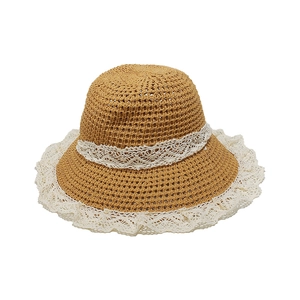 Detail of breathable hollow straw weave with wide white lace trim on the summer sun hat