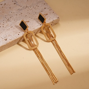 Boucles d'oreilles pompons dorées 18K avec carré noir sur un support en pierre