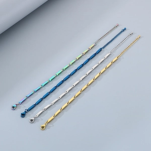 Set of four stainless steel chain bracelets in rainbow, blue, silver, and gold finishes