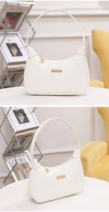 Detail of white lychee pattern hobo bag with gold metal plate and leaf zipper pendant