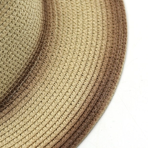 Detailed macro view of woven natural straw fibers in khaki and brown striped pattern
