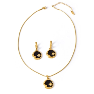 Golden sun and moon necklace set with black enamel star charms and crystal accents