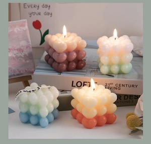 Macro view of gradient heart cube candles with ribbons and aesthetic props