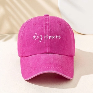 Hot pink baseball cap with dog mom embroidery and paw print design in a minimalist style