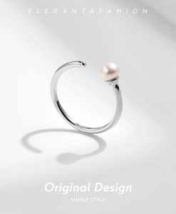 Macro detail of 925 sterling silver ring featuring a natural pink pearl on grey background