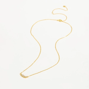 Close-up of golden S925 silver necklace featuring five sparkling zircon gemstones