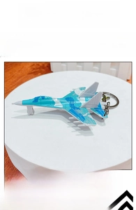 Detailed close-up of blue camo fighter jet keychain with silver metal ring and clip