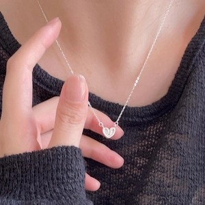 Minimalist 925 sterling silver heart pendant necklace shown on a model neck