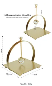 Detail view of gold iron napkin holder with a crystal ball weight and square base