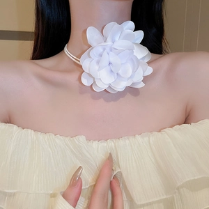 Close-up of elegant white fabric flower necklace on model for versatile styling