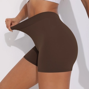Macro detail of high-elasticity fabric on high-waist coffee yoga shorts with hand stretching