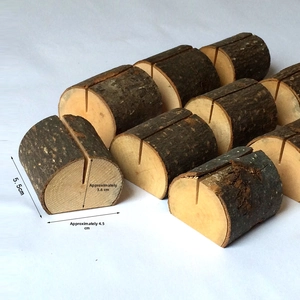 Detailed view of semi-cylindrical wooden card holder showing natural bark texture and slots