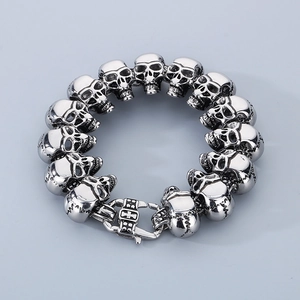 Detail of silver skull link bracelet with intricate cross pattern on the sturdy metal clasp
