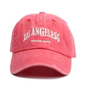Detail of coral pink washed denim baseball cap with white vintage embroidery