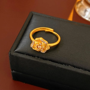 Detailed close-up of a vintage golden floral zircon ring with textured petal finish