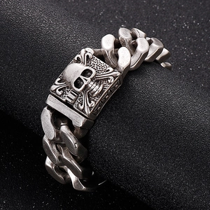 Men's silver stainless steel Cuban link bracelet with skull and crossbones emblem