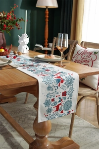 Detailed texture of Christmas table runner with red reindeer and bells on wooden table