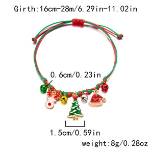 Detail of handmade Christmas bracelet with reindeer and tree charms on red green cord