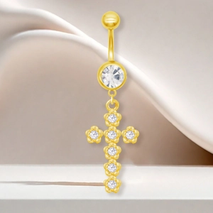 Gros plan détaillé du piercing de nombril doré en acier avec pendentif croix brillant