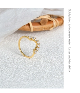 Macro detail of 18k gold plated curved ring featuring sparkling zircon inlay details