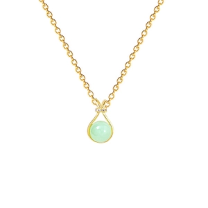 Detailed close-up of light green gemstone pendant with gold border and sparkling accents