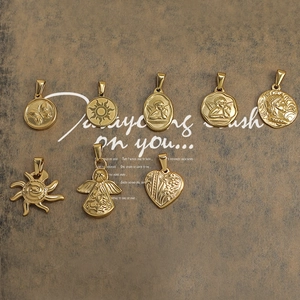 Collection of retro gold pendants featuring angels, sunbursts, and coin portraits