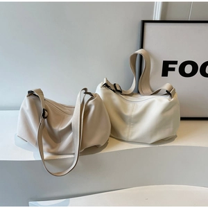 Detailed view of beige and cream minimalist tote bags with adjustable wide shoulder straps