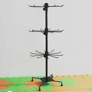 Rotating black metal jewelry stand with three tiers and hooks for keychain display