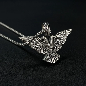Detailed close-up of a silver stainless steel double-headed eagle pendant with punk style