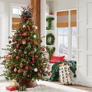 Cozy home setting featuring a decorated Christmas tree with red berries and warm lights