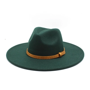 Detail of dark green wool fedora hat featuring a brown crocodile textured leather band