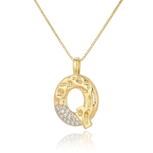 Macro detail of gold letter Q pendant with sparkling zircon stones on a box chain necklace