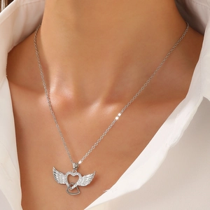 Angel wings and interlocking heart pendant necklace with rhinestones on a female model