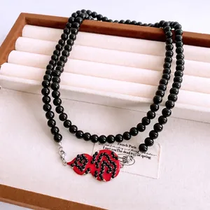 Vintage beaded double-layer necklace with a vibrant red gourd pendant and silver lobster clasp