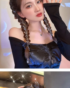 Detailed view of silver sparkling braided hair chain with sequins on a long ponytail