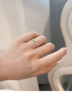 Detail of V-shaped sterling silver ring with pavé-set zircons on hand