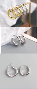 Close-up of 18K gold and silver hoop earrings featuring the S925 hallmark engraving